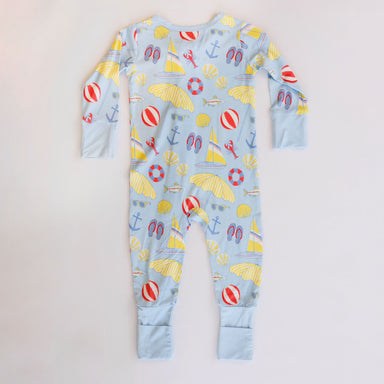 Children's onesie with beach-themed print on a white background
