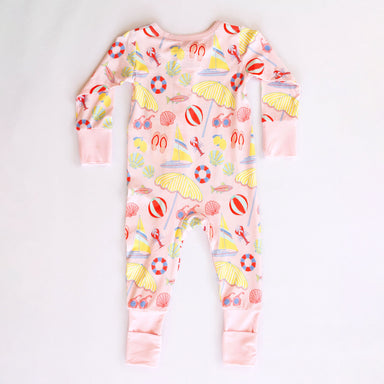 Children's onesie with beach-themed print on a white background