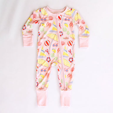 Pink baby onesie with colorful beach-themed print on a white background