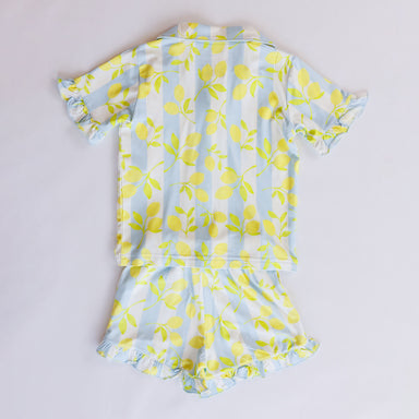 Children's pajamas with lemon pattern on a light gray background
