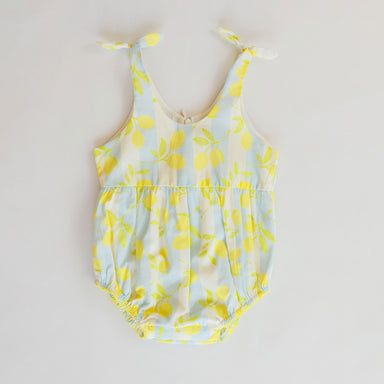 Blue romper with lemon pattern on a white background