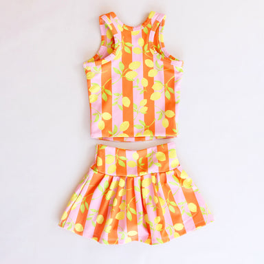 Children's two-piece outfit with orange, pink, and yellow striped pattern on a white background