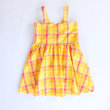 Yellow and pink plaid dress on a white background