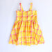 Yellow and pink plaid dress on a white background