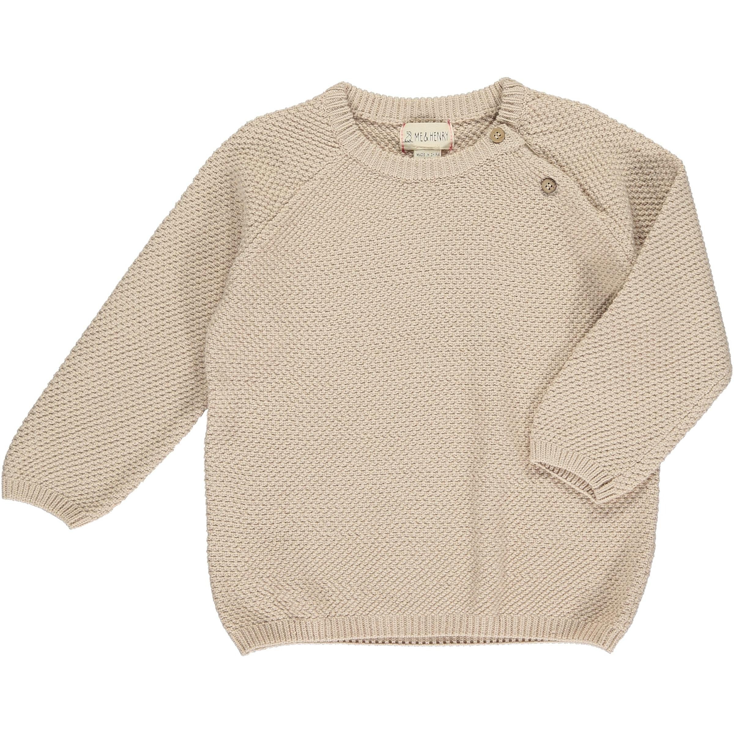cream colored sweater with two button closure at the neck