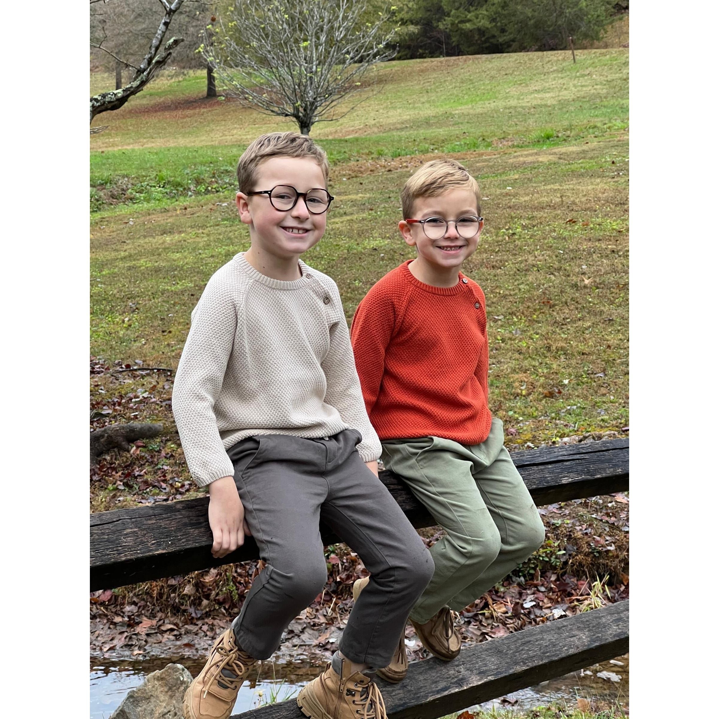 boy wearing oatmeal colored knit sweater with button closure