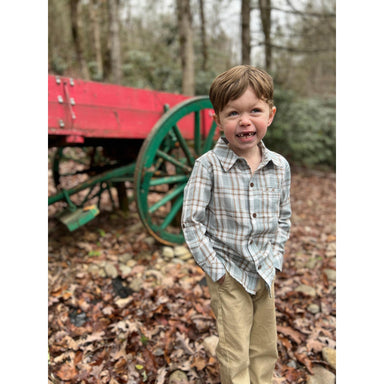 boy wearing light blue, white and brown plaid long sleeve button down