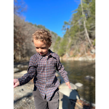 boy wearing brown, navy and grey plaid long sleeve button down