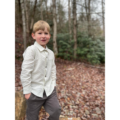 boy wearing charcoal gray twill pants with white button down shirt