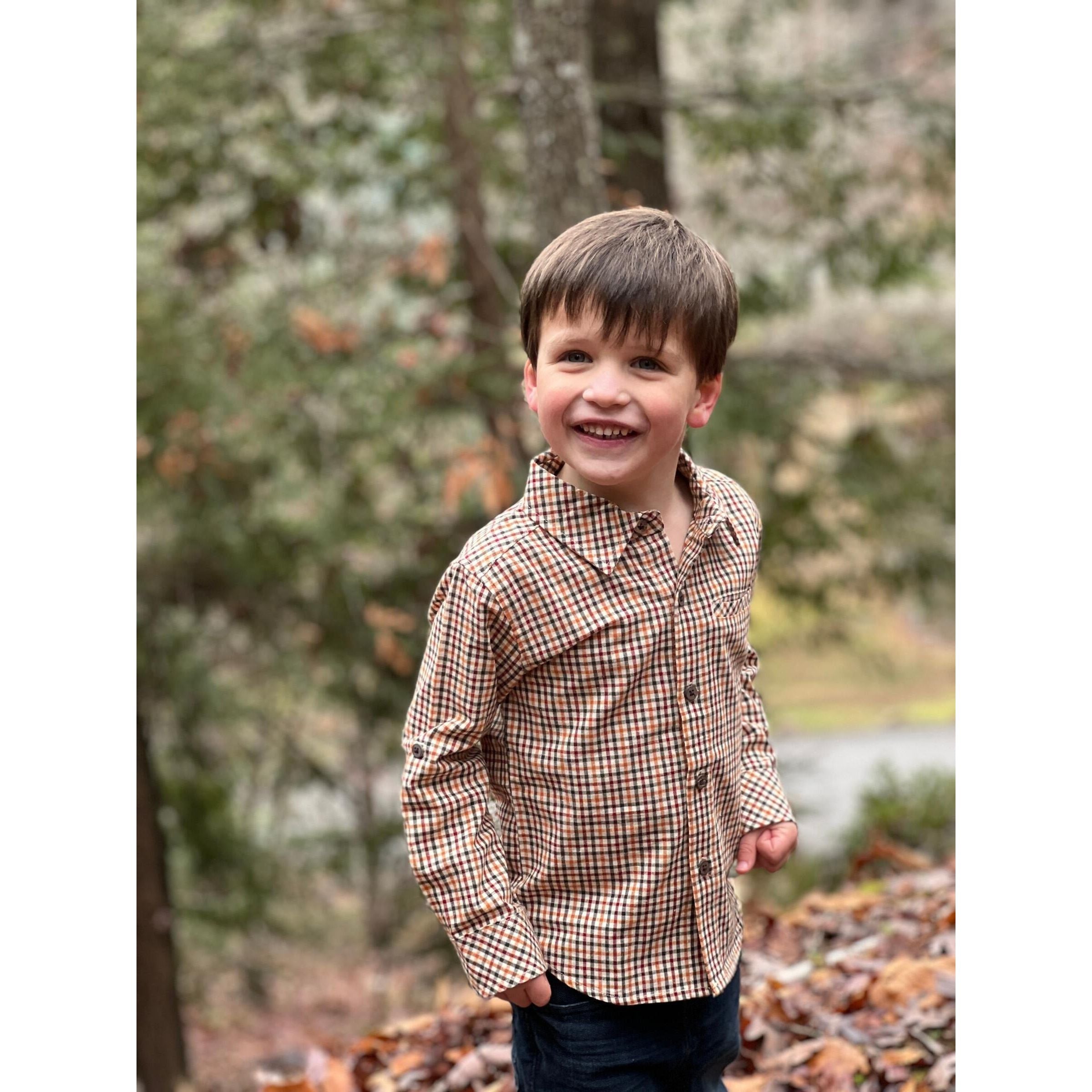 boy wearing green, red and yellow plaid long sleeve button down