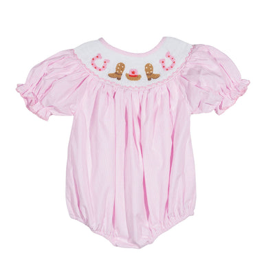 Pink baby romper with embroidered cowgirl details on a white background