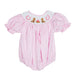 Pink baby romper with embroidered cowgirl details on a white background