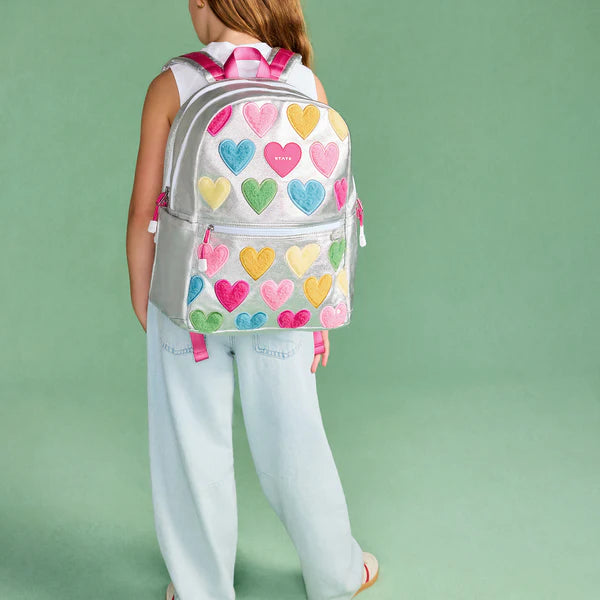 Girl with a Happy Fuzzy Hearts Double Pocket Backpack on her back