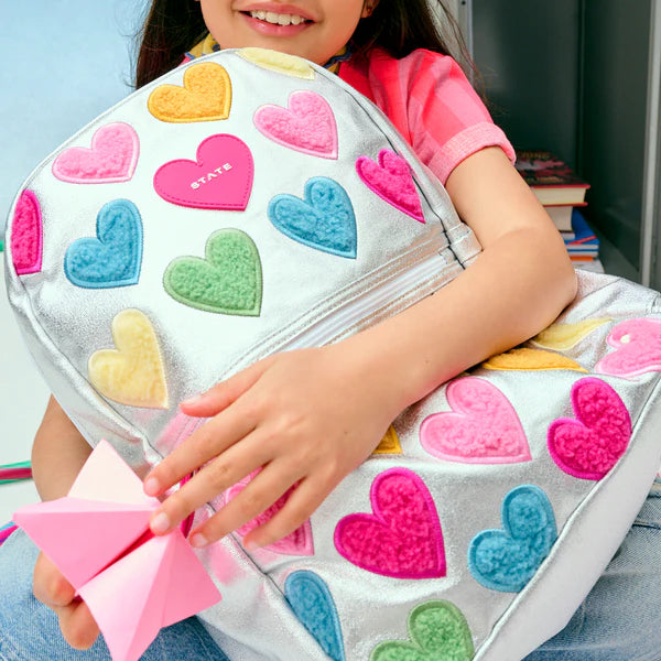 Girl carrying a Happy Fuzzy Hearts Double Pocket Backpack