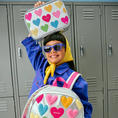 Girl with multi colored Happy Fuzzy Hearts Rodgers Lunchbox on her head