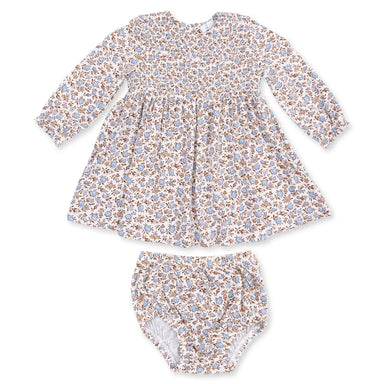 A baby girl's two-piece outfit set consisting of a long-sleeve smocked dress and matching bloomers, featuring a delicate blue and brown floral pattern on a cream background.