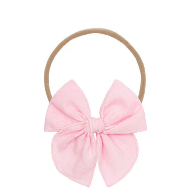 Pink bow hair accessory on a white background