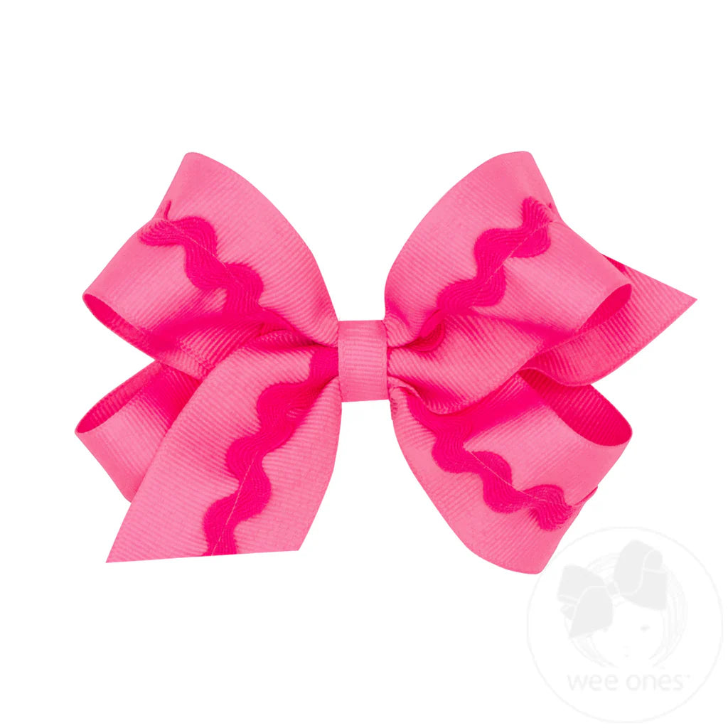 Pink hair bow with wavy pattern on a white background