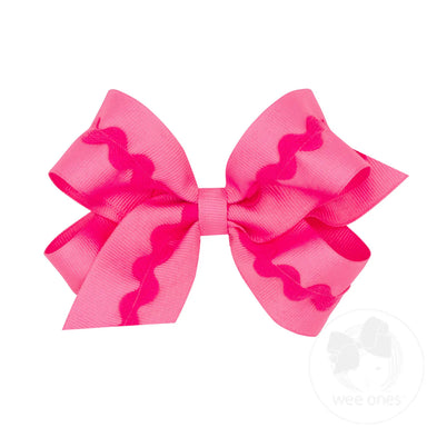 Pink hair bow with wavy pattern on a white background