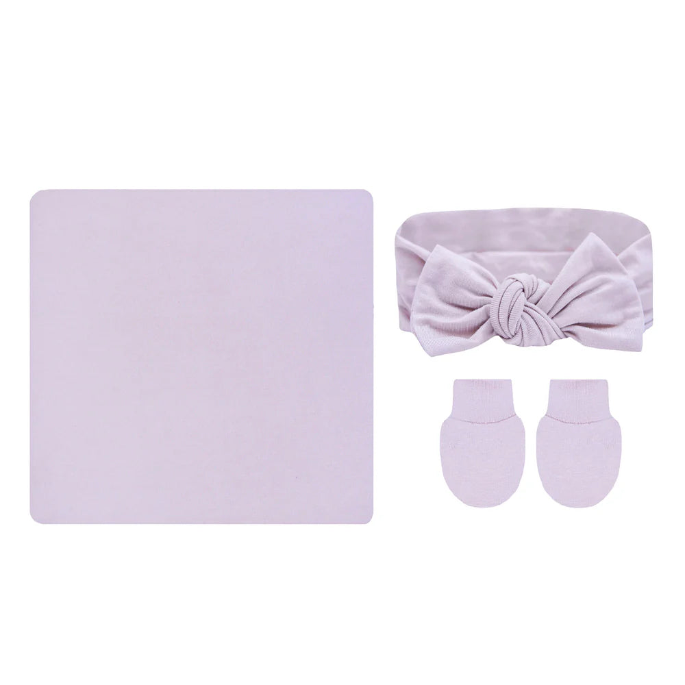 Baby accessory set with headband, socks, and blanket in light purple on a white background