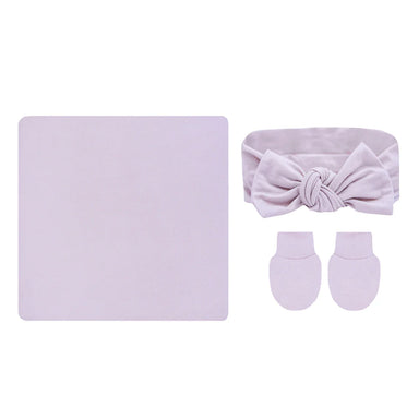 Baby accessory set with headband, socks, and blanket in light purple on a white background