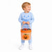 A young child wearing a light blue sweatshirt and matching pants stands against a white background holding an orange gingham Halloween candy basket with a jack-o'-lantern face.