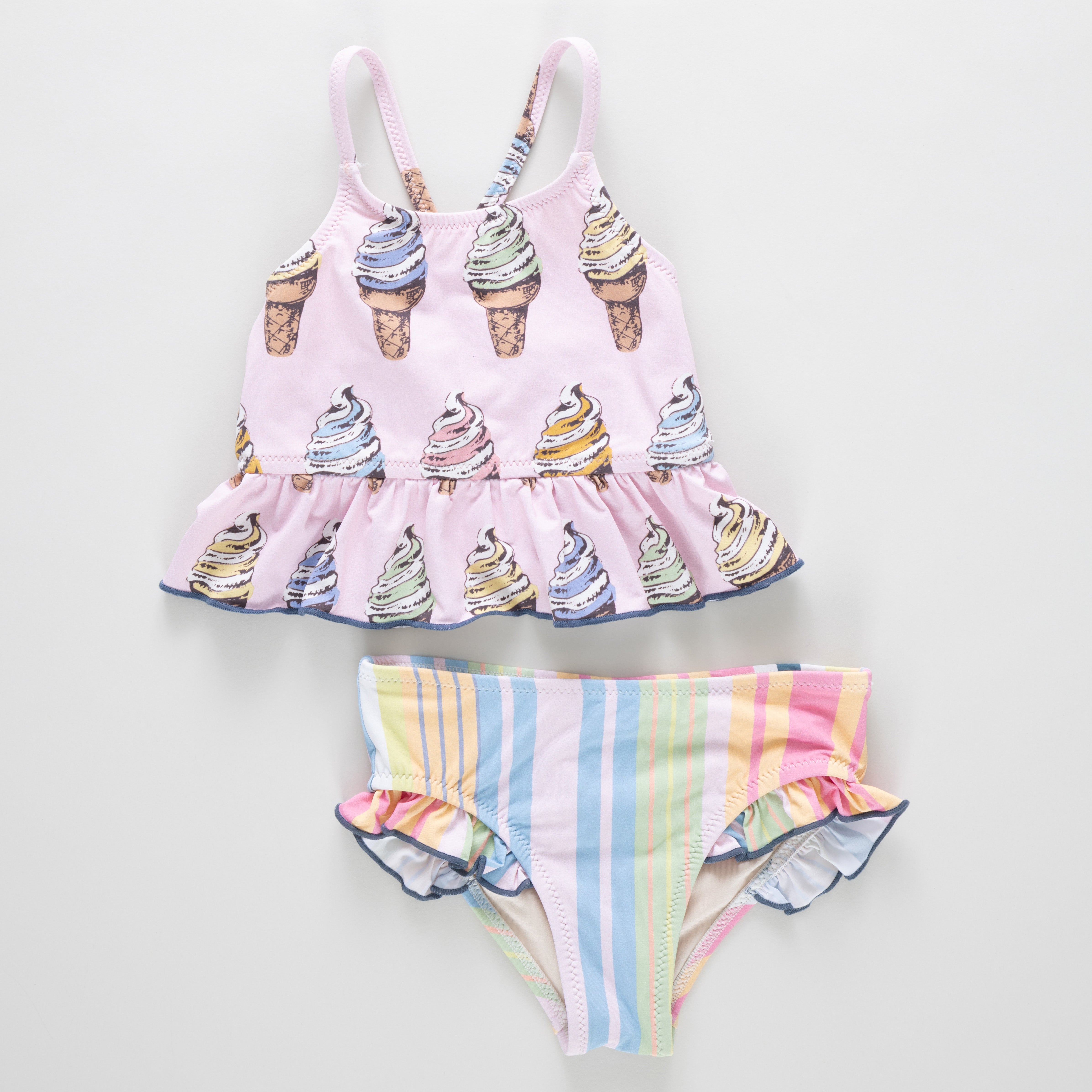 Children's swimsuit set with ice cream cone top and striped bottom on a light gray background