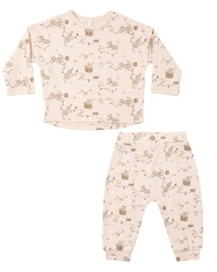 A two-piece baby sweatsuit featuring a long-sleeve top and matching pants in a light cream color with a delicate brown and beige whimsical kitty print, displayed on a solid white background.