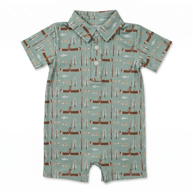 A baby short-sleeve polo romper in sage green with an all-over print of brown logs, pine trees, and figures in canoes, featuring a three-button collar.