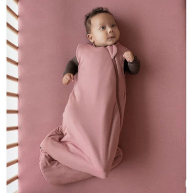 baby wearing dusty rose colored sleep bag