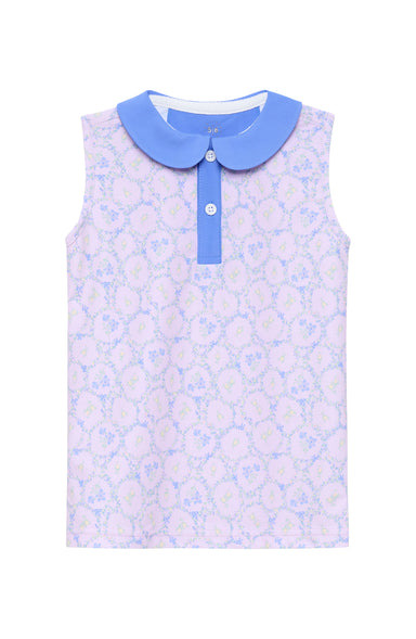 Sleeveless dress with floral pattern and blue collar on a white background