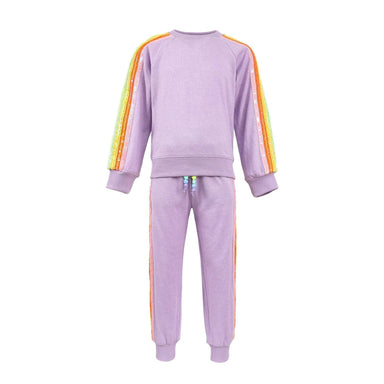 A children's two-piece tracksuit in light purple, featuring a long-sleeve sweatshirt and matching jogger pants. The sleeves and side of the pants have vertical rainbow stripes in red, orange, yellow, green, and blue.