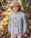 A young boy wearing a khaki colored snapback hat featuring brim rope and embroidered "Local Cowboy" graphic on the front panel.