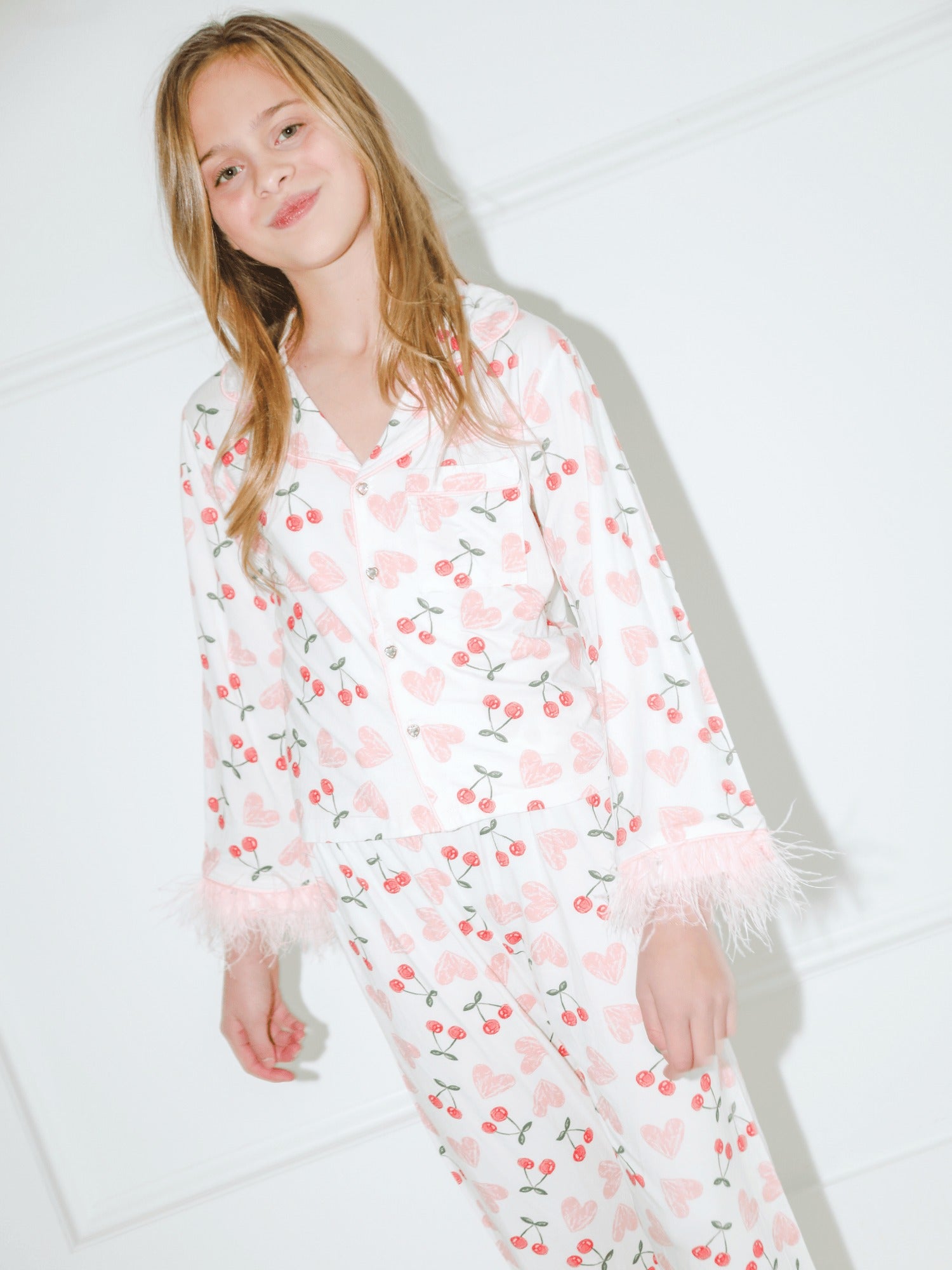 Woman wearing a cherry and heart pattern set with a white background