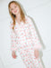 Woman wearing a cherry and heart pattern set with a white background