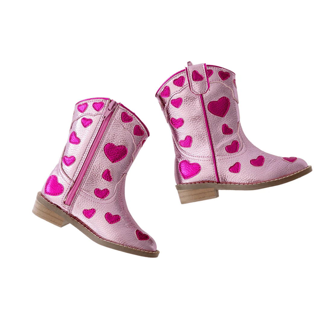 Pink cowboy boots with heart patterns on a white background