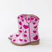 Pink children's boots with heart patterns on a white background