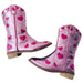 Pink cowboy boots with heart patterns on a white background