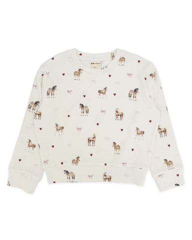 An ivory colored top with a horse and hearts print