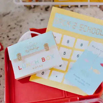 Back-to-school themed items including a calendar and stationery on a red tray.
