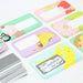 Set of colorful name tags with cartoon designs on a white background