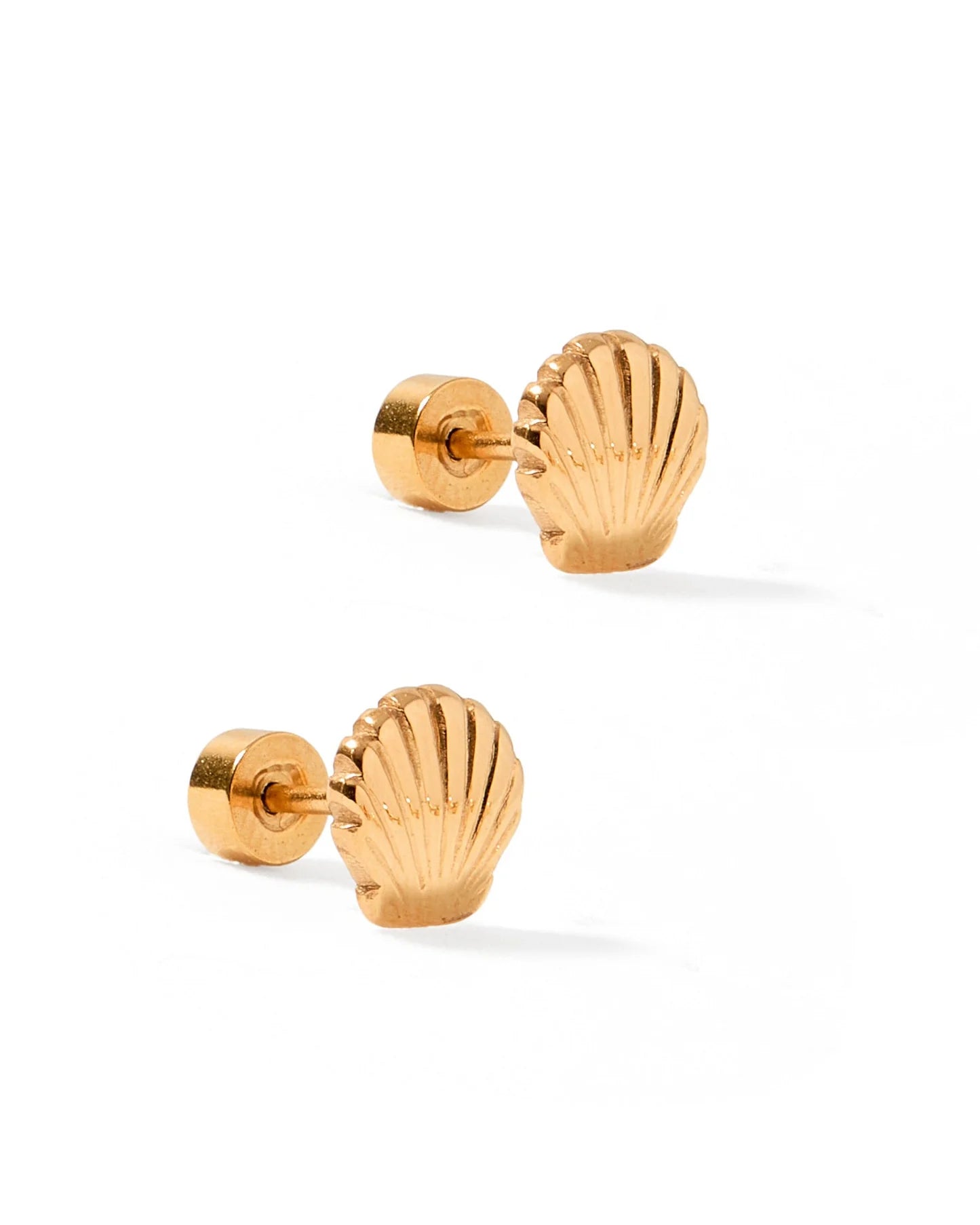 Pair of gold shell-shaped earrings on a white background