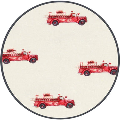 Round fabric sample with red fire truck pattern on a white background