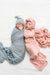 Two babies wrapped in baby blue and pink blankets