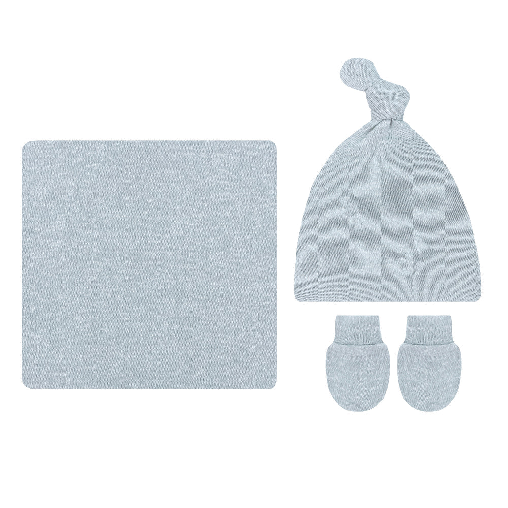 A baby knit gift set in a light blue heathered fabric, including a square blanket, a knotted beanie hat, and a pair of mittens, arranged on a plain white background.