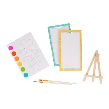 Art supplies including a color chart, small easel, and paintbrushes on a white background