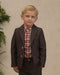 Young boy modeling a dark heathered plaid blazer with notched lapels and front pockets over a red plaid shirt with coordinating trousers from Noralee