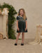A green velvet dress featuring a smocked bodice, puff sleeves with lace trim, and a scalloped lace Peter Pan collar.