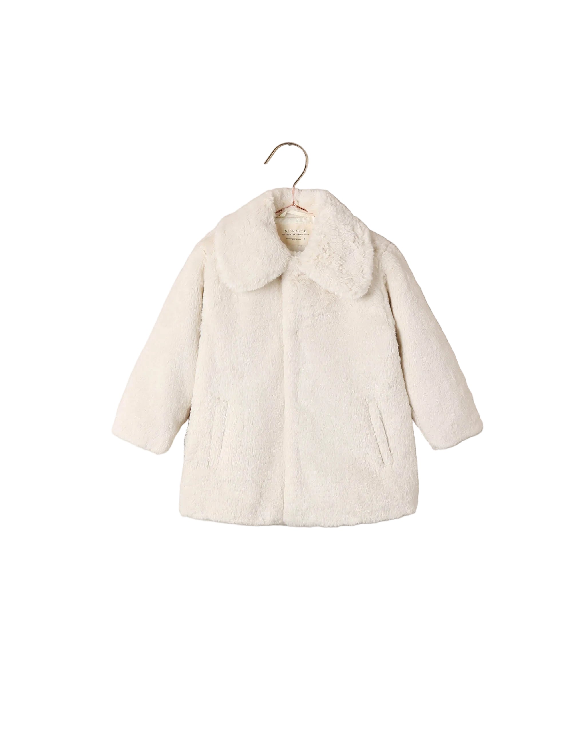 Noralee natural faux fur coat for children with an oversized collar long sleeves hidden front closure and side pockets displayed on a hanger
