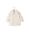 Noralee natural faux fur coat for children with an oversized collar long sleeves hidden front closure and side pockets displayed on a hanger